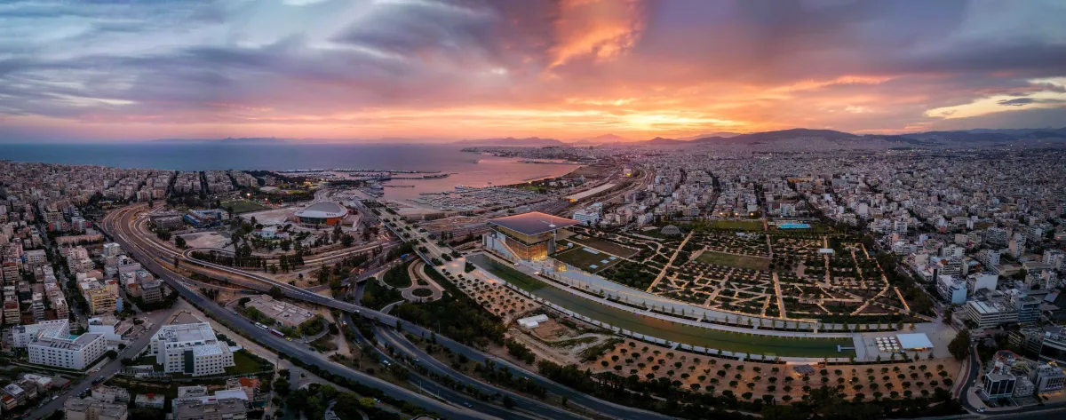 Aerial view of a cultural complex, park and coast at sunset
